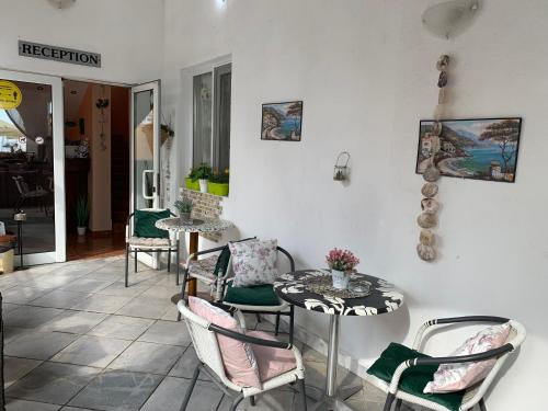 a living room with a table and chairs at Sea Square Hotel in Balchik