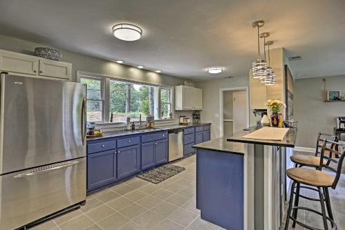a kitchen with blue cabinets and a stainless steel refrigerator at Family-Friendly Escape about 6 Mi to City Center! in Chattanooga