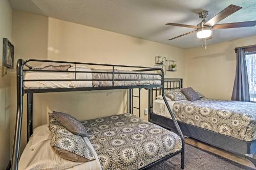 a bedroom with two bunk beds and a ceiling fan at Breck Ski-InandSki-Out Condo on Peak 8 with Patio in Breckenridge