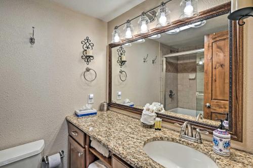 a bathroom with a sink and a large mirror at Breck Ski-InandSki-Out Condo on Peak 8 with Patio in Breckenridge