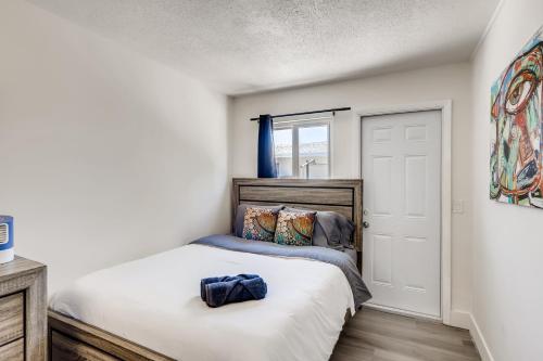 a bedroom with a bed with a blue backpack on it at !!Coral Sands 1 Bedroom Stunner!! in West Palm Beach