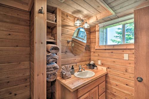 a bathroom with a sink in a wooden cabin at The Front Porch 20-Acre Country Home with Mtn View in Red Lodge