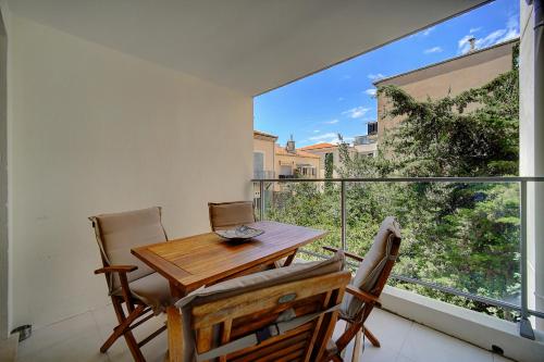une salle à manger avec une table et des chaises sur un balcon dans l'établissement 2 PIECES MODERNE AVEC TERRASSE ET PARKING A 3MN DES PLAGES !l- A1B230, à Cannes