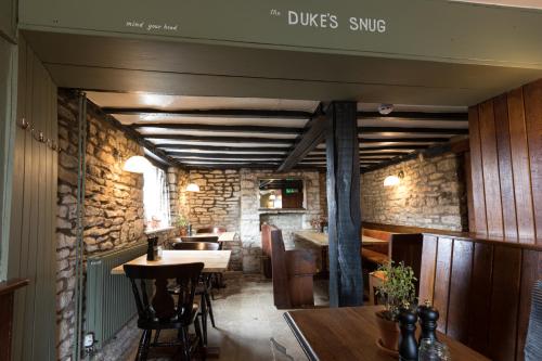 a dining room with a table and some chairs at Duke Of Marlborough in Woodstock