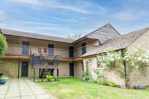 an exterior view of a house with a balcony at Duke Of Marlborough in Woodstock