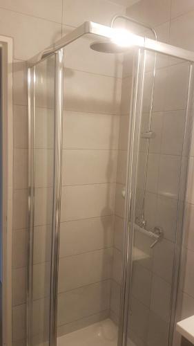 a shower with a glass door in a bathroom at NEW CHEAP PRIVATE ROOM, KITCHEN , OVERWIEUW sea,TRAM on spot, 12 minutes from nice train station with tram , beach in 17 min tram , CHAMBRE PRIVÉE pas cher, cuisine équipée , tram sur place, APERÇU mer, 12 min de la gare de Nice avec le tram, 17 min plage in Nice