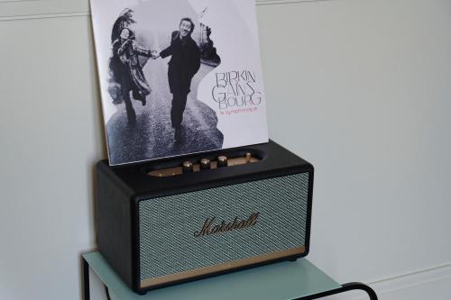 a black and white radio on a table with a poster at My Maison In Paris - Champ de Mars in Paris