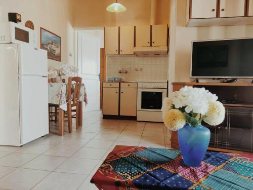 a kitchen with a vase of flowers on a table at Kostas Skondros Studio in Saoúli
