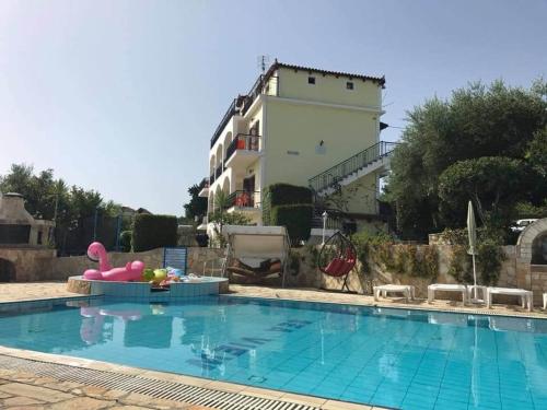 a swimming pool in front of a building at SeaView Apartments in Tsilivi