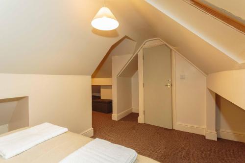 an attic room with a bed and a light at Cherry Property - Coconut Suite in Blackpool