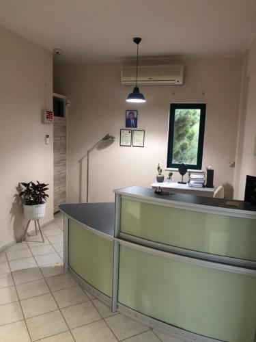 a waiting room with a reception counter in a hospital at Amalia Hotel in Kalogria