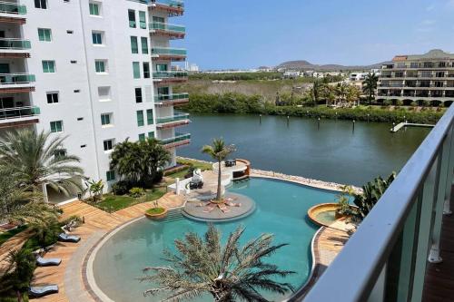 a view of a swimming pool from the balcony of a building at 5010 depa Pacifika de lujo en Marina Mazatlán in Mazatlán