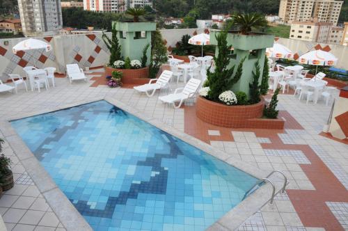 a swimming pool on the roof of a building at Serra Negra Paladium Hotel in Serra Negra