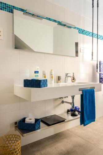 a white bathroom with a sink and a mirror at CASANTILVIA heated pool paradise in Adeje