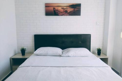 una camera da letto con un grande letto con due comodini di Deluxe Apartment by Prima Lodging a Salonicco