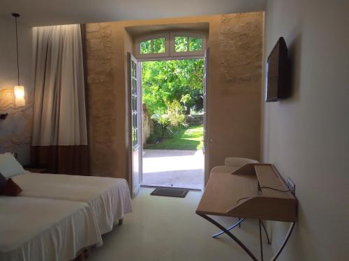 a room with two beds and an open door at AUX DUCS DE SIENNE in Montagne