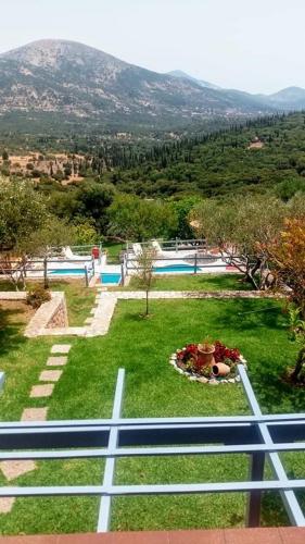a view of a garden with a swimming pool at Il Suo Paradiso in Dhavgáta