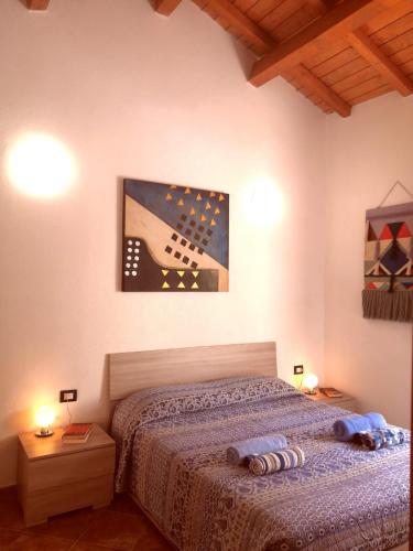 a bedroom with a bed and a picture of a guitar at La Dimora in Teulada