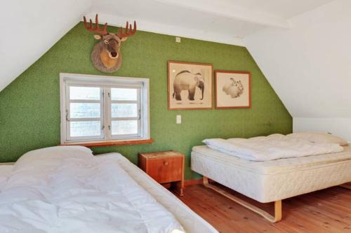 Postel nebo postele na pokoji v ubytování Hyggeligt gammelt fiskerhus i Marstal