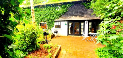 a house with a brick patio in front of it at Charming Victorian Coach House in Jordanstown