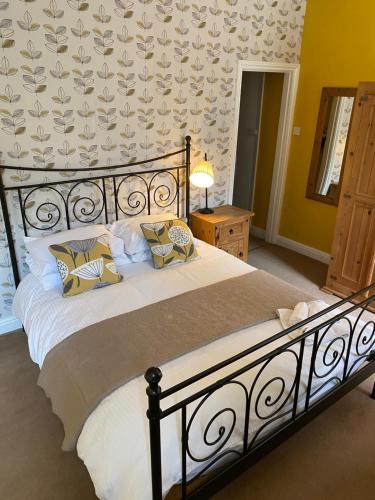 a bed with a white bedspread and pillows in a bedroom at The White Horse Inn in Holmfirth
