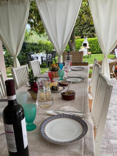a table with a bottle of wine and a plate of food at Villa La Baia a pochi passi dal lago in San Felice del Benaco