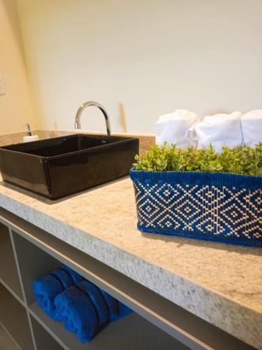 a kitchen counter with a sink and some towels at POUSADA ATALAIA NORONHA in Fernando de Noronha