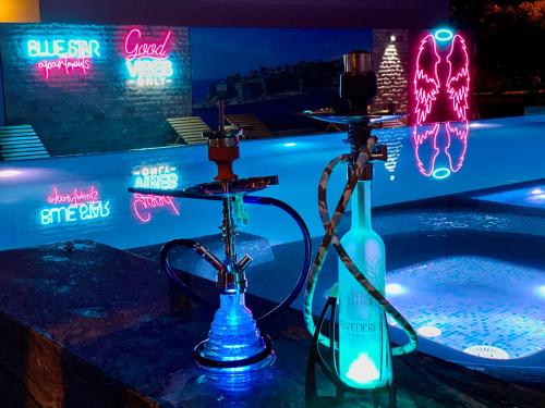 a hot tub with two bottles and neon signs at Blue Star Apartments in Ulcinj