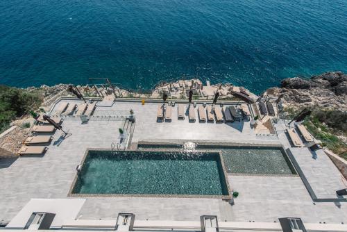 an aerial view of a swimming pool next to the ocean at Dollaku Apartments in Bar
