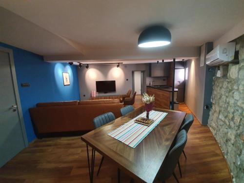 a living room with a table and a couch at MIAU Premium apartments in Selce