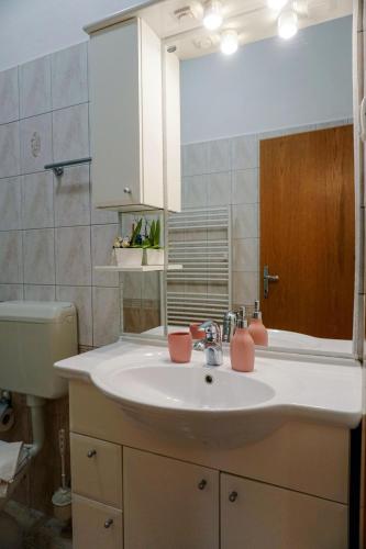 a bathroom with a sink and a mirror at Villa Cvita in Lumbarda