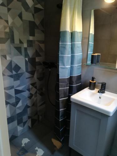 a bathroom with a sink and a shower at 2SEA VILLA Nea Potidea CHALKIDIKI in Nea Potidaea