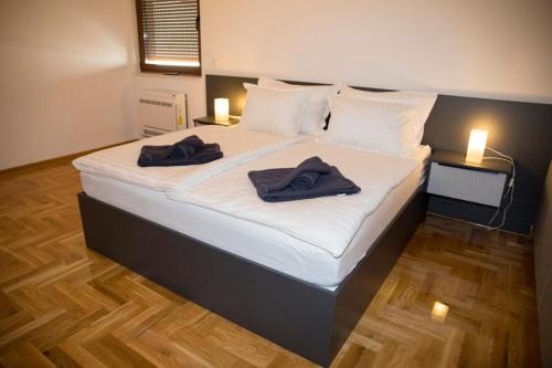 a bedroom with a bed with two towels on it at Penthouse with Old bridge view and jacuzzi in Mostar