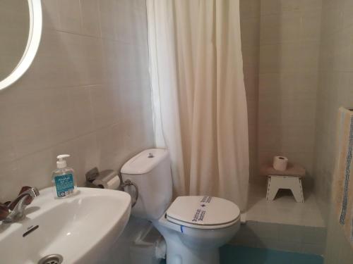 a bathroom with a white toilet and a sink at MiMA2 JACA in Jaca