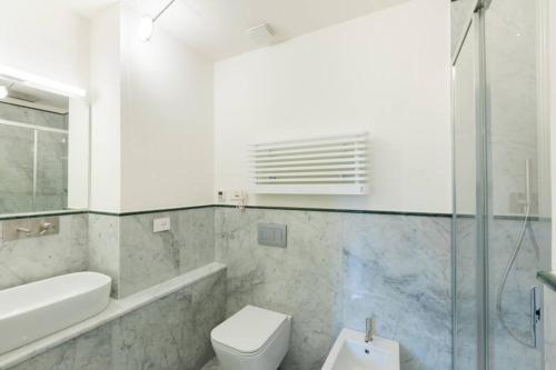 a bathroom with a toilet and a sink and a shower at Ponte Vecchio Luxury Flat in Florence