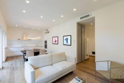 a living room with a white couch and a table at Ponte Vecchio Luxury Flat in Florence
