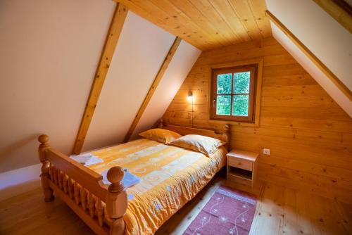 a bedroom with a bed in a attic at Cottages Kravanja in Trenta