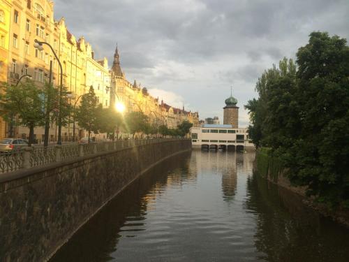 a river in the middle of a city with buildings at Holec Apartments in Prague