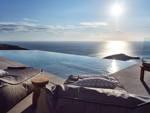 a swimming pool with a view of the ocean at Etheria Luxury Villas & Suites in Agios Nikolaos