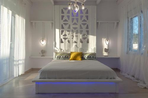 a bedroom with a large bed with yellow pillows at Seva's House in Psinthos