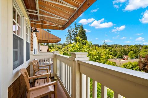 a balcony with two chairs and a view of the mountains at Saratoga Inn in Langley