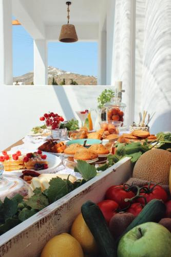 a buffet of fruits and vegetables on a table at Aeron Suites in Éxo Goniá