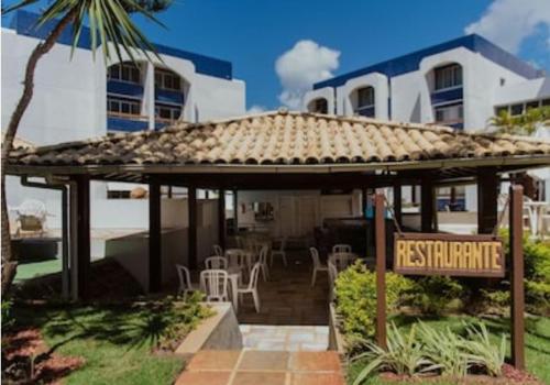 a gazebo with a restaurant sign in front of a house at BEACH APARTMENT IN VILAS DO ATLANTICO in Lauro de Freitas