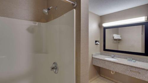 a bathroom with a sink and a mirror at Best Western Pontiac Inn in Pontiac