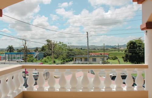 a white balcony with a view of a street at Discovery Beach Apartments in Aguada