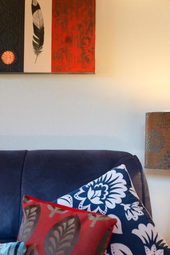 a blue couch with two pillows on it at Chalet Romantica in Paihia
