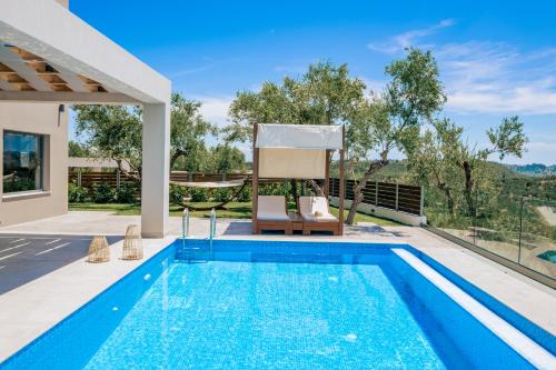 a swimming pool in the backyard of a house at Villa Plumeria in Tsilivi