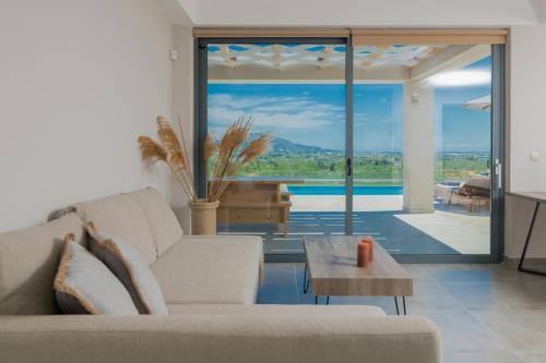 a living room with a couch and a table at Villa Plumeria in Tsilivi