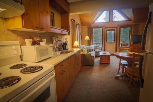 a kitchen with a stove top oven and a sink at Paradise Lodge and Bungalows in Lake Louise
