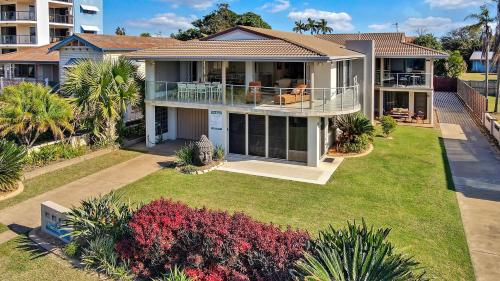 an aerial view of a house with a yard at Nautilus Beachside Apartments in Bargara